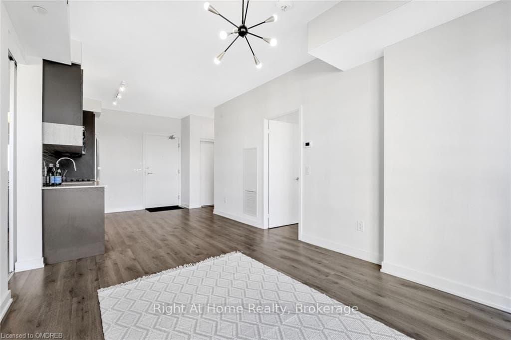 Unfurnished living room with a notable chandelier,
