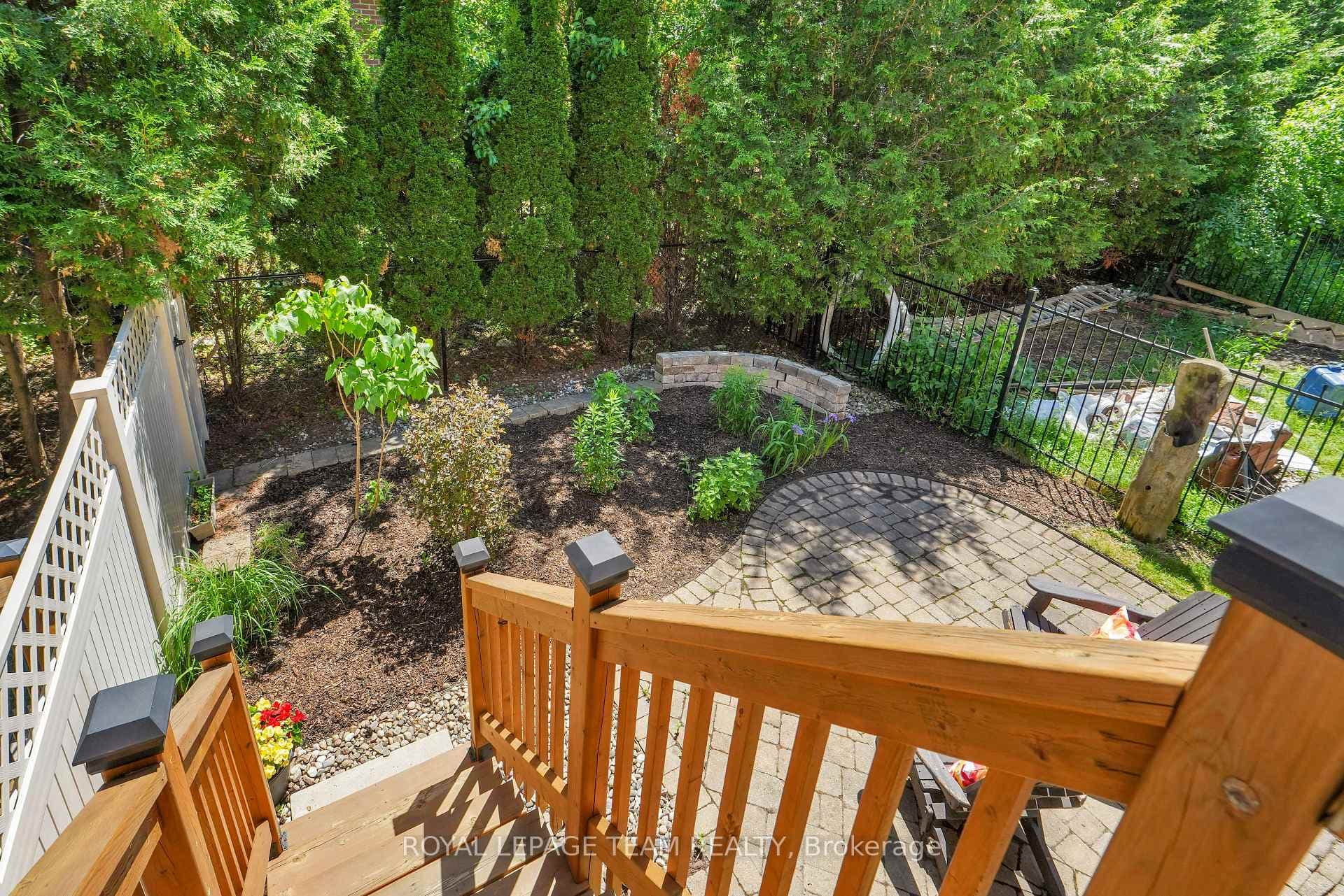 STAIRS TO GARDEN WITH BRICK PATIO.