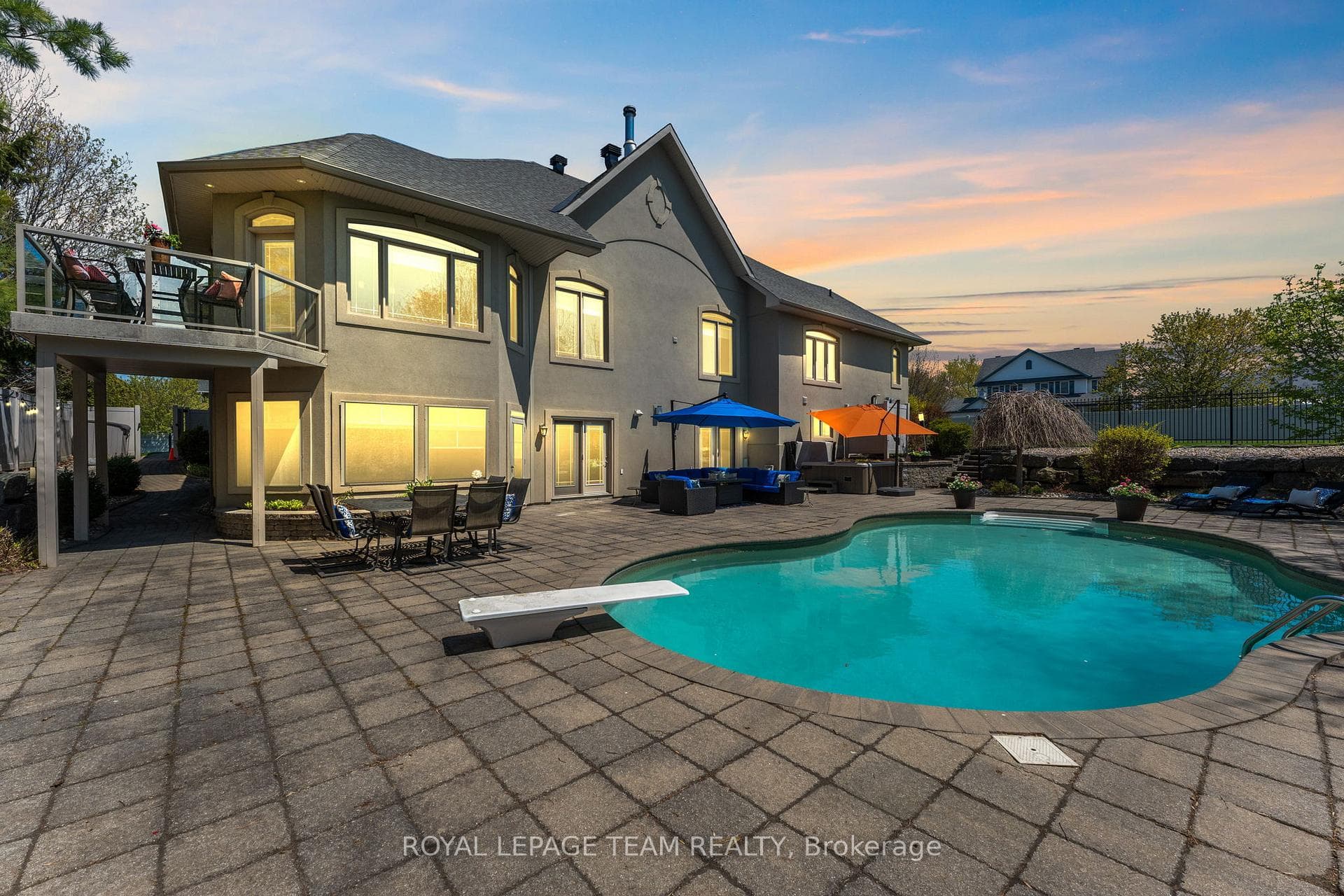 Deck off of the kitchen with view of the pool