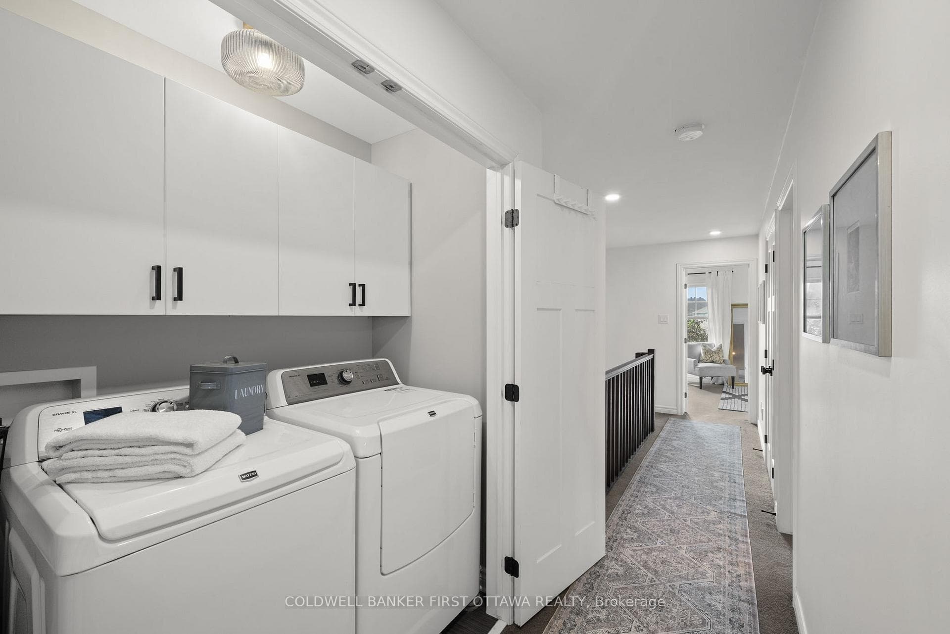2nd level Laundry with cabinets.
