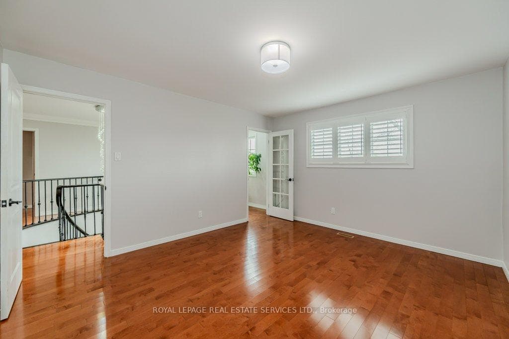 Third Bedroom w/ a Hardwood Floor & Cali Shutters