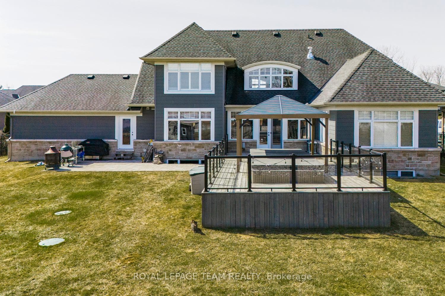 Expansive backyard with deck, pergola & swim spa.