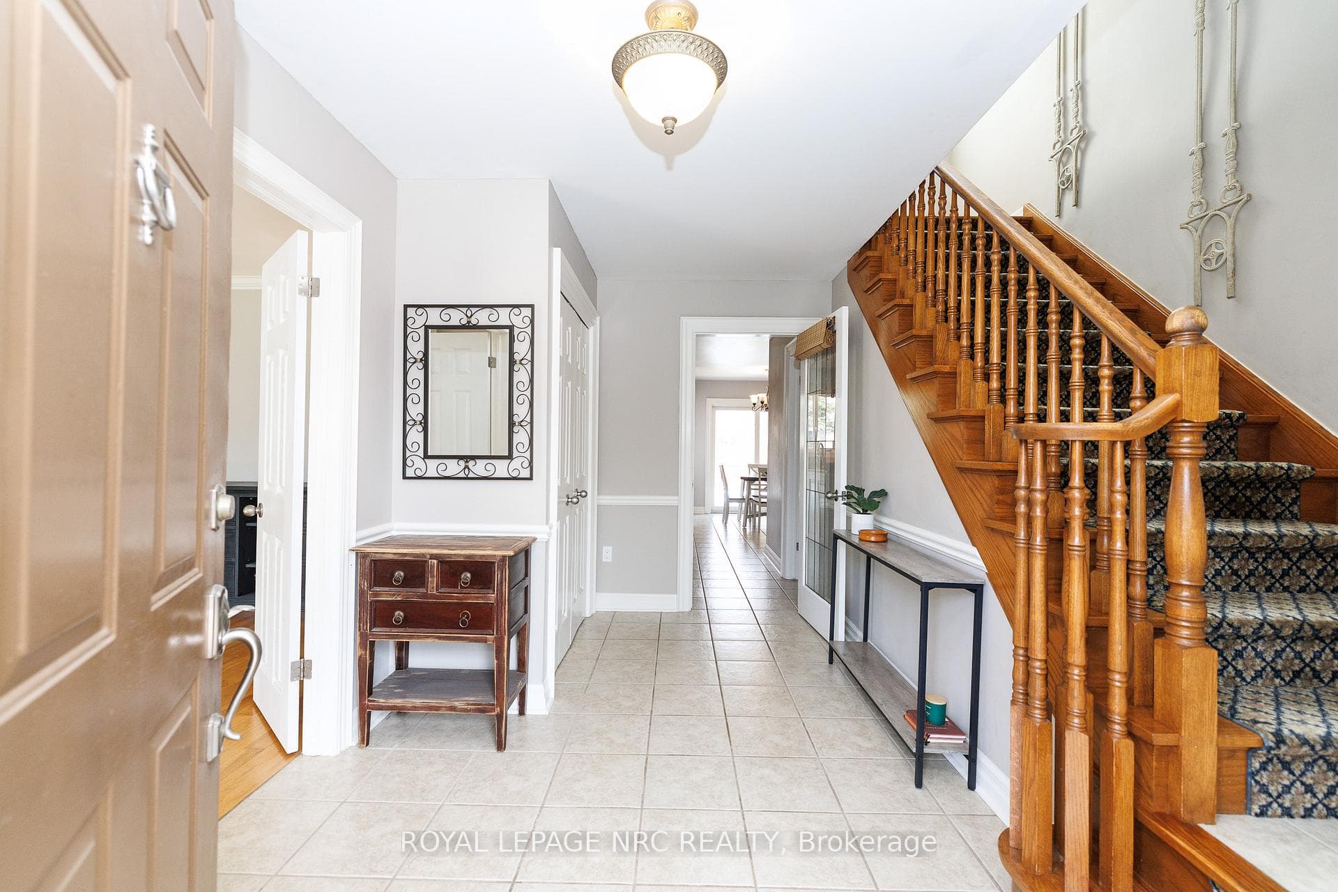 Inviting front foyer with double coat closet