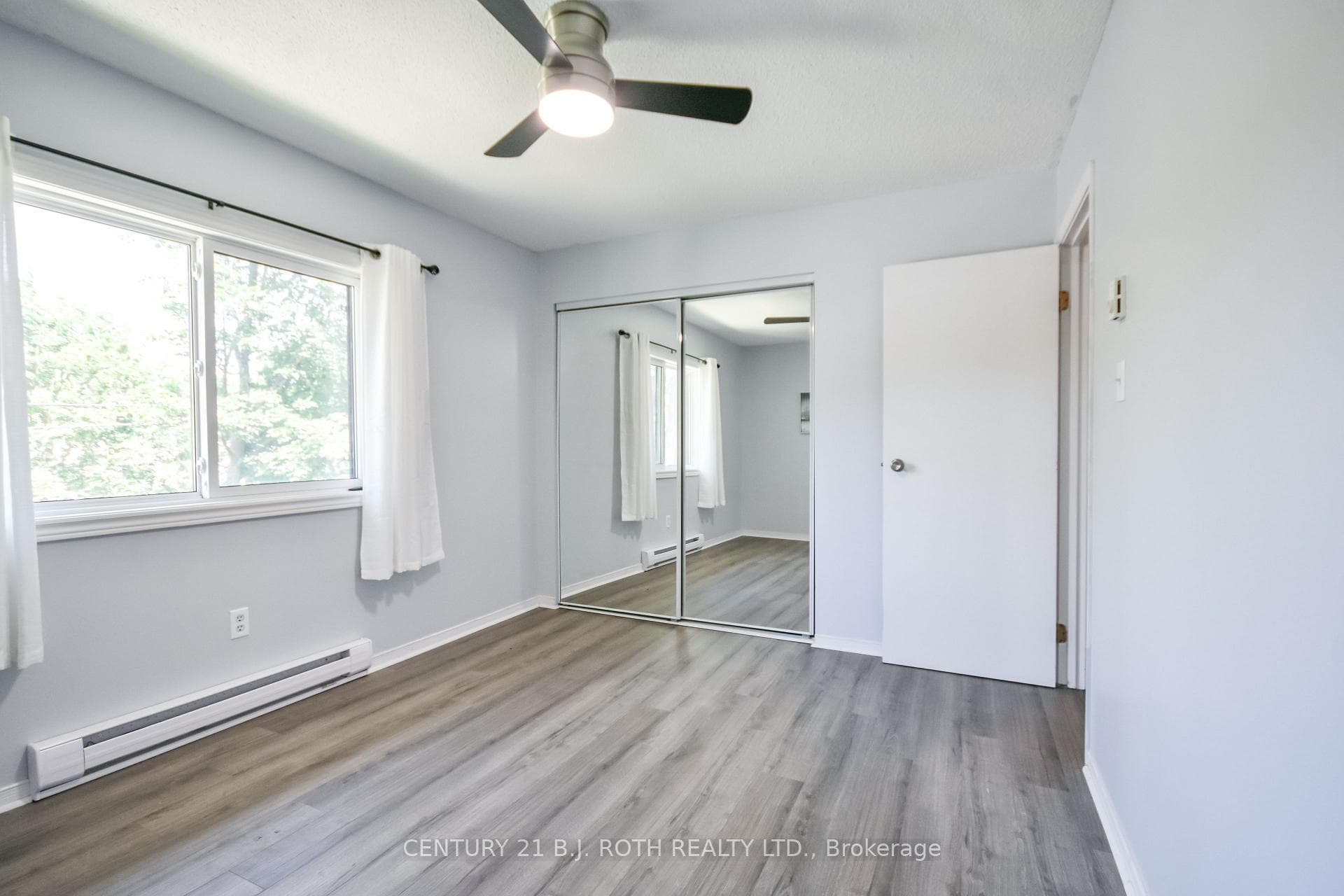 Primary bedroom w a large mirrored double closet.