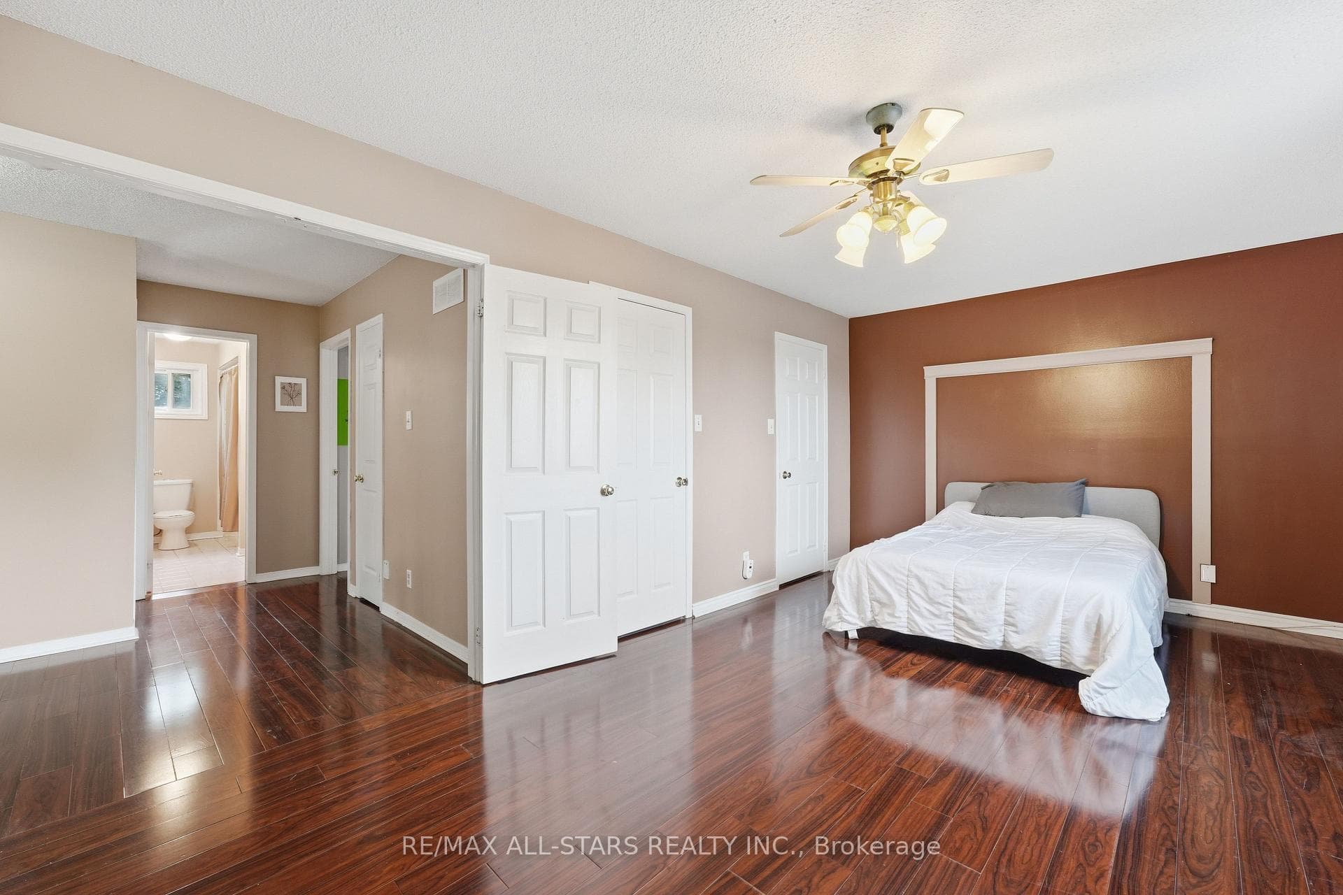 Large primary bedroom with double door entry