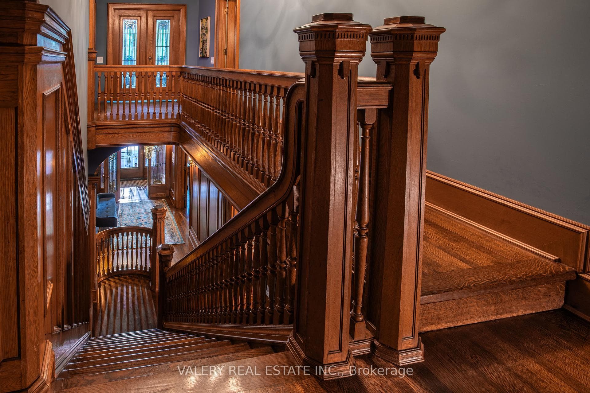 Grand Wood Staircase with Carved Newel Posts