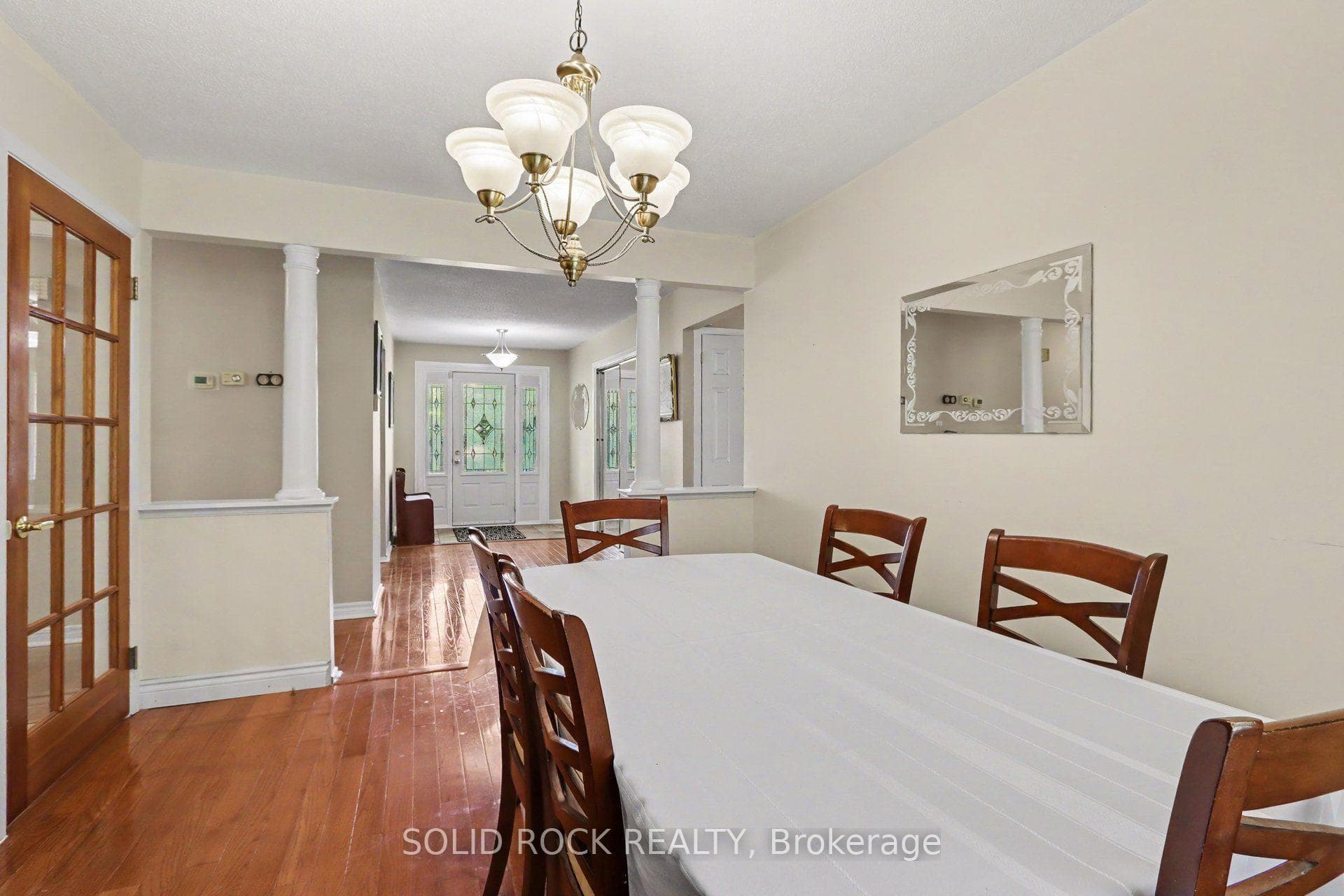 Dining room with columns opening to entrance