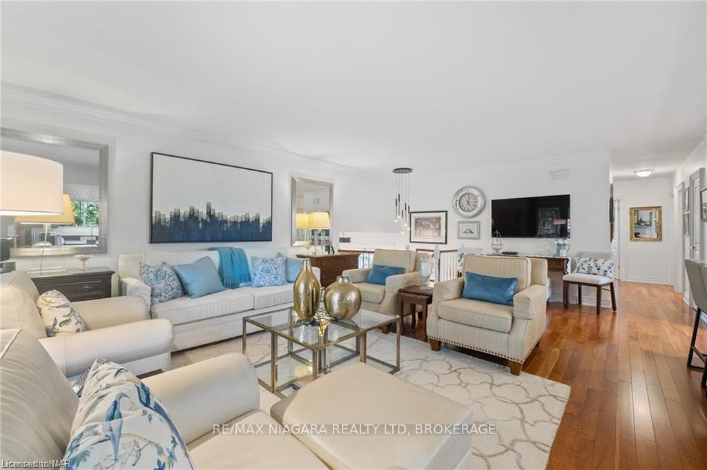 Living room with hardwood / wood-style flooring an