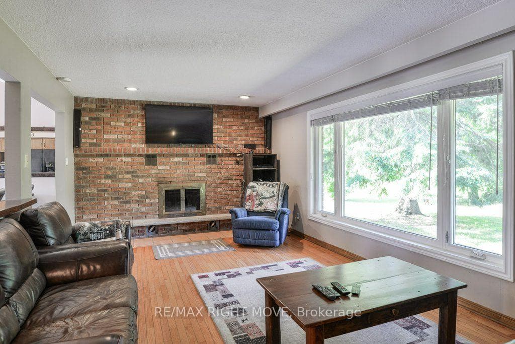 Living room with brick wood burning fireplace.