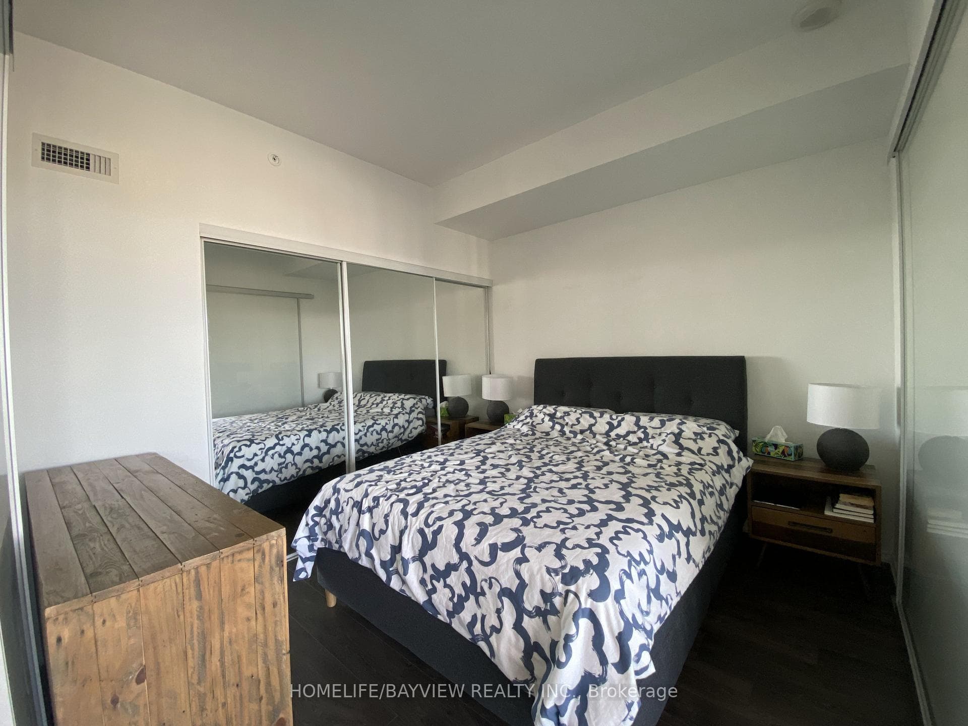 Bedroom featuring large triple door closet
