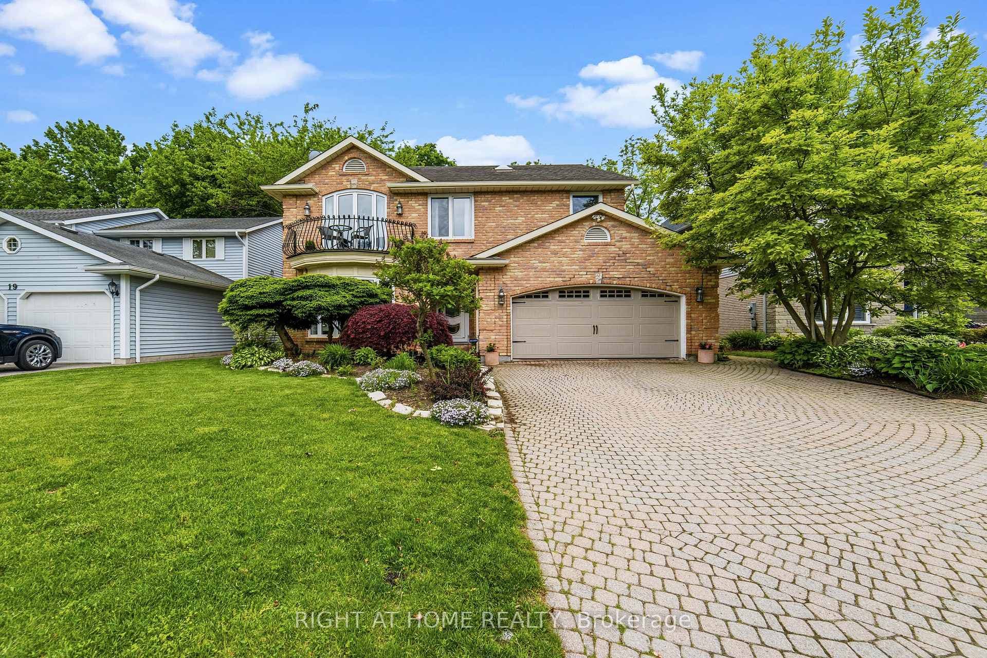 Front of House with large cobble stone driveway