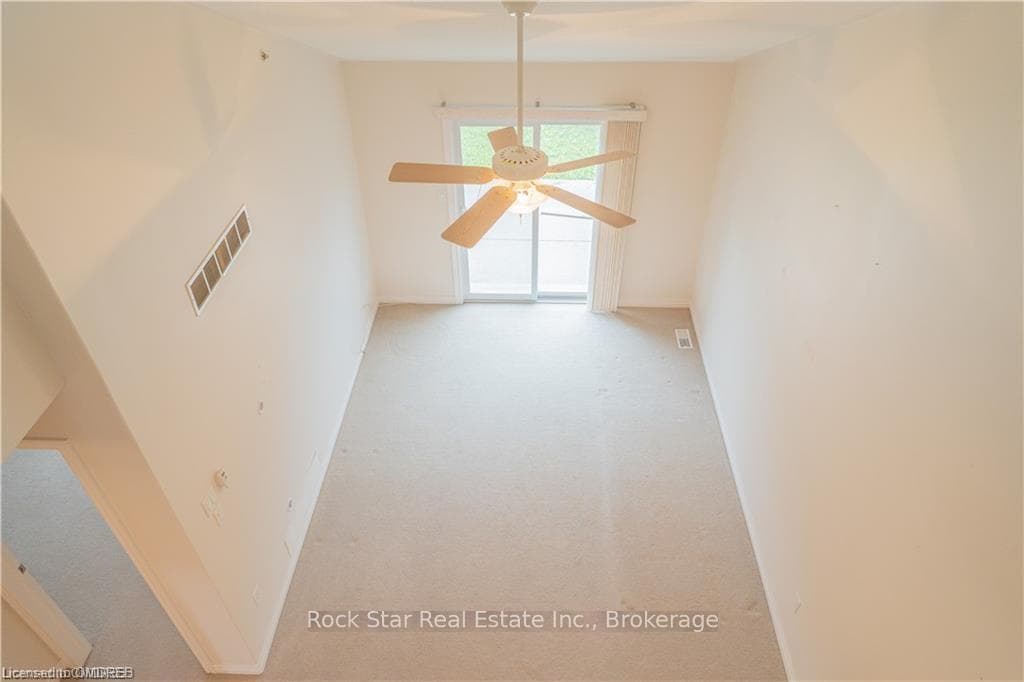 Bonus room featuring light carpet and ceiling fan