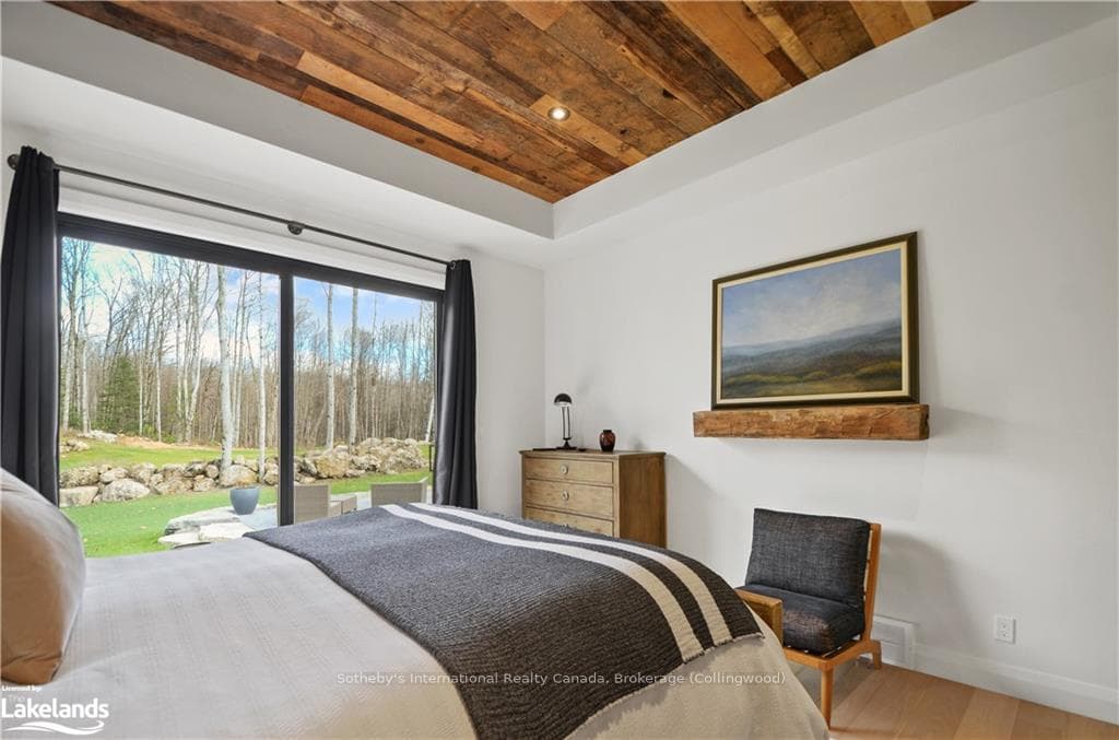 Bedroom featuring multiple windows, hardwood / woo