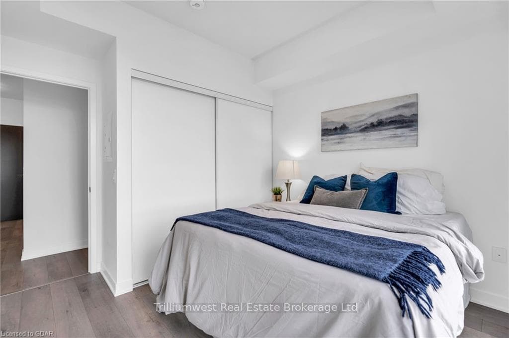Bedroom featuring dark wood-type flooring and a cl
