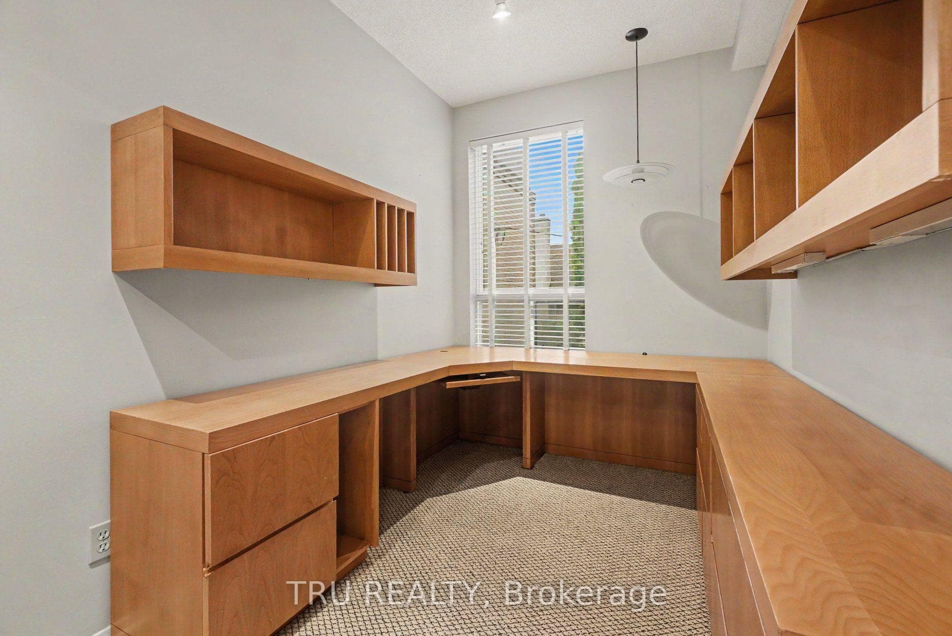 Office with built in desk and cabinetry