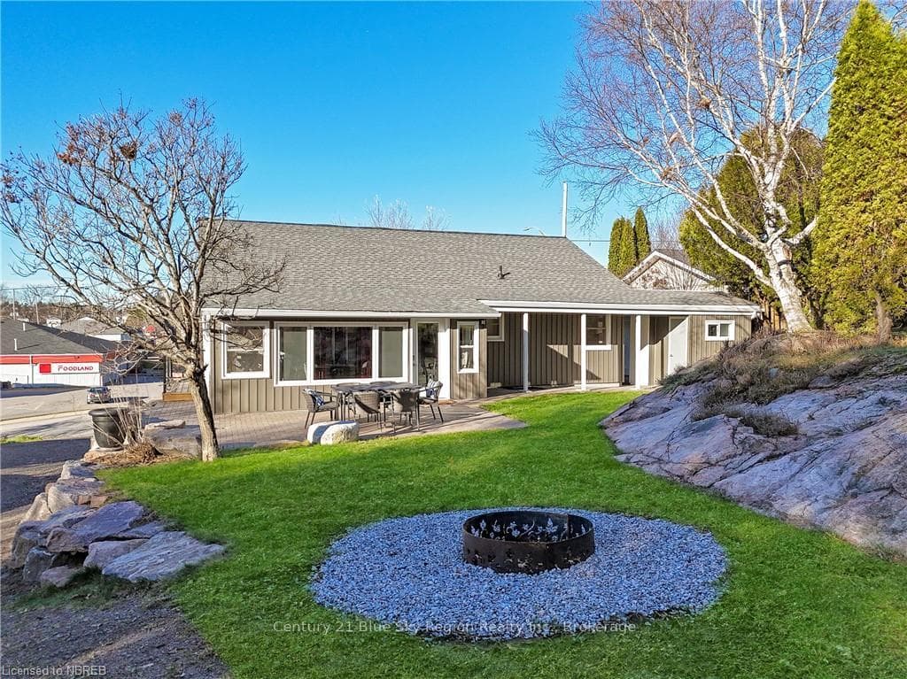 Back of house with a patio area, a yard, and a fir