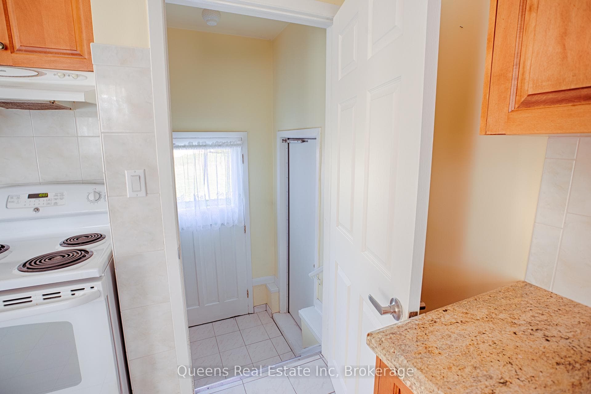entrance to lower level, garage & back yard