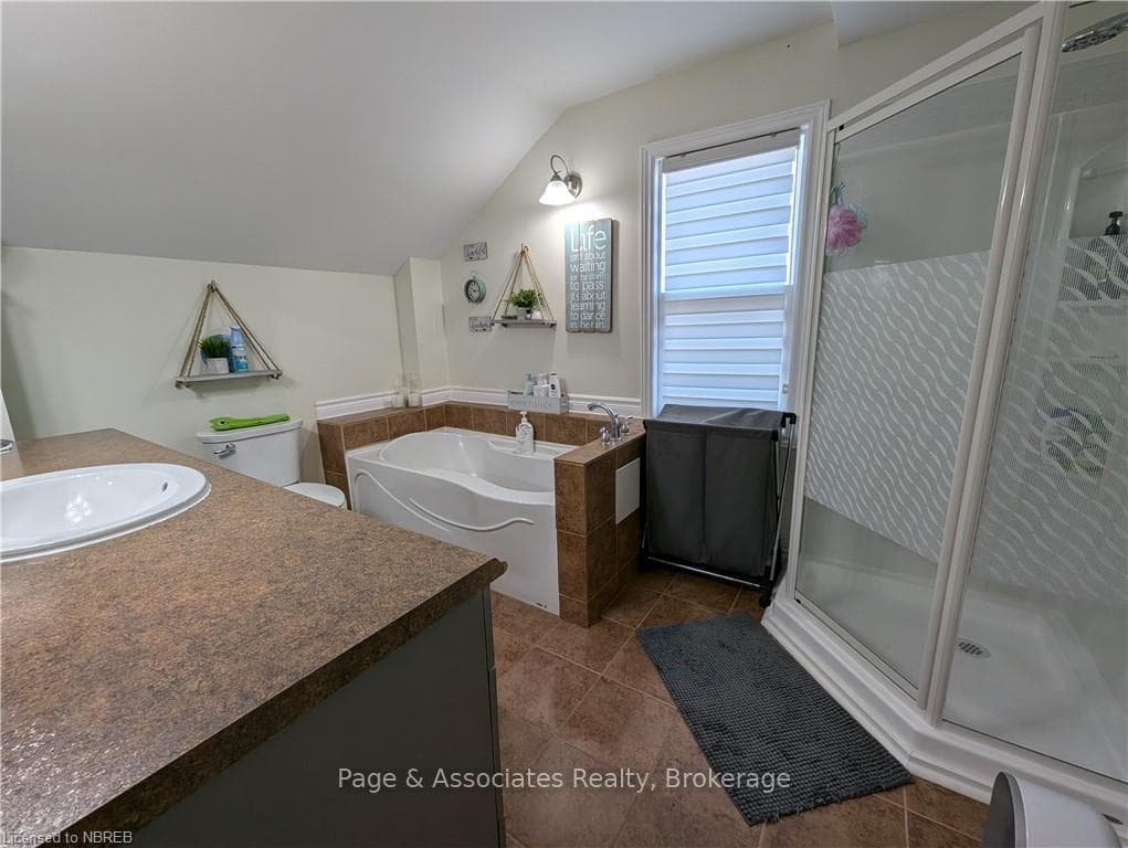 Bathroom featuring tile patterned flooring, a tub