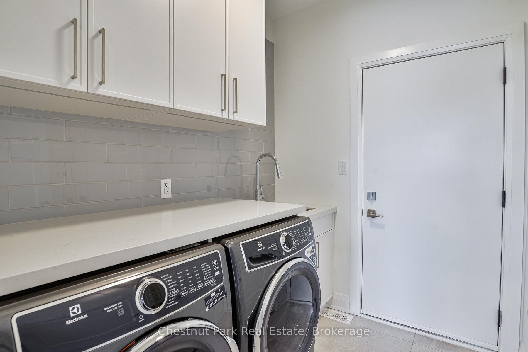 ENTRY TO GARAGE FROM LAUNDRY ROOM WITH WASH TUB