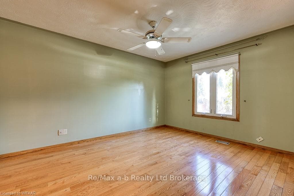 Empty room featuring a textured ceiling, light woo