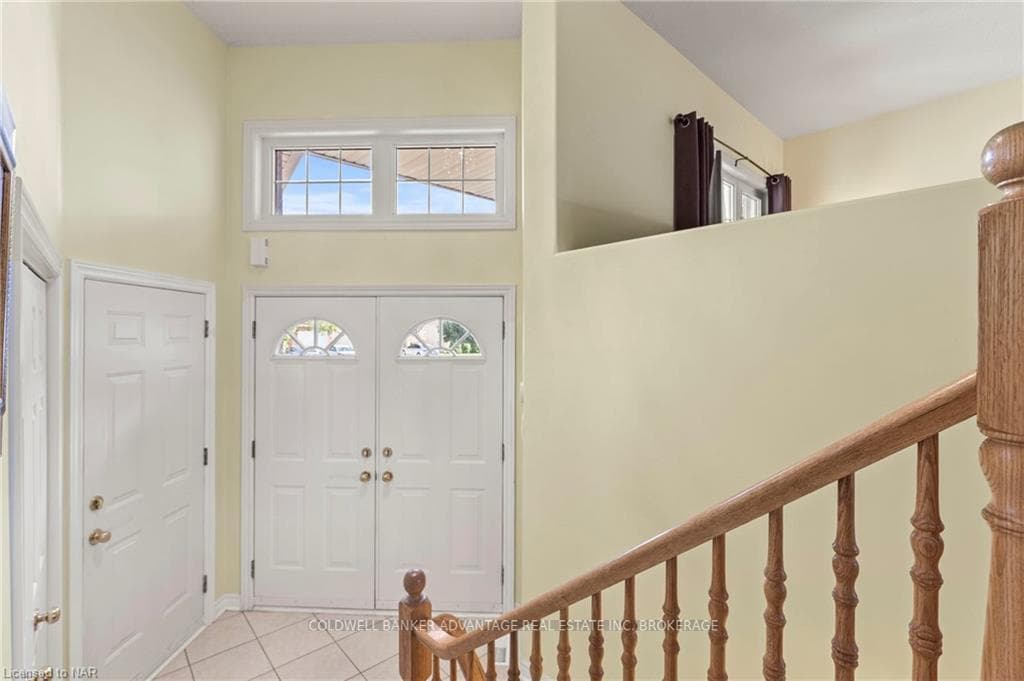 View of the front entry way with high ceilings. T