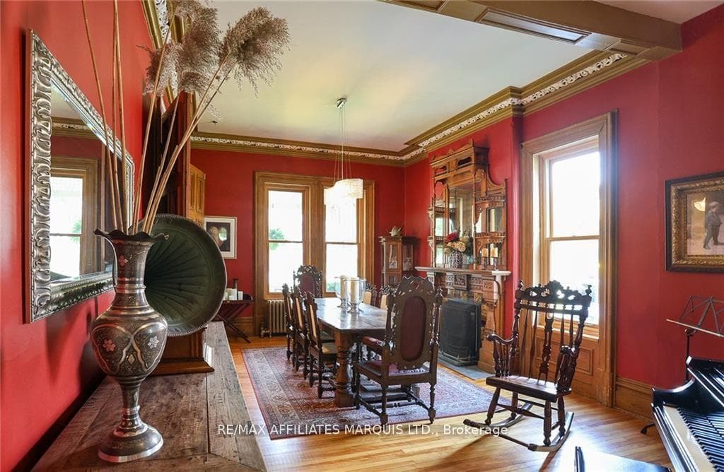 Sizeable And Ornate Dining Area With Wood Floors