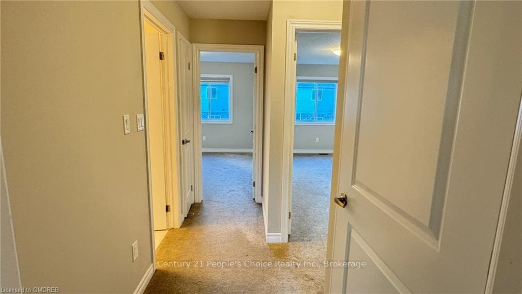 Hall featuring light colored carpet