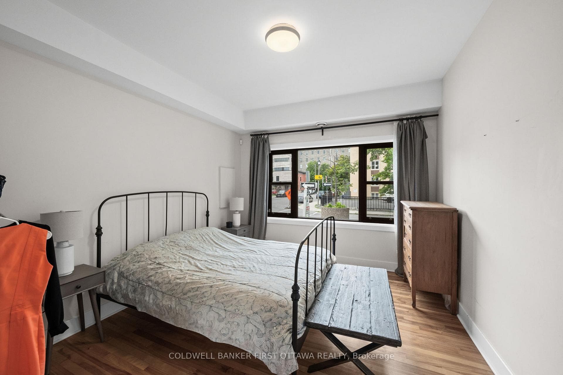 Bedroom w bright wall to wall window.