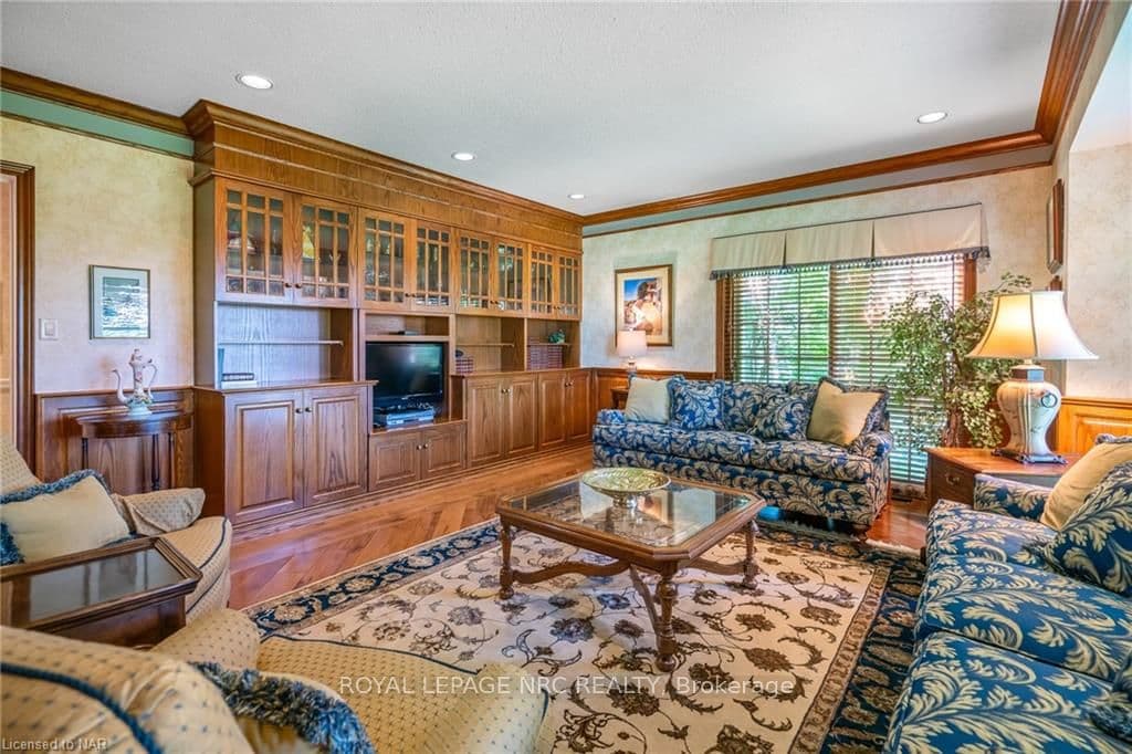 The richly paneled walls of the family room & warm