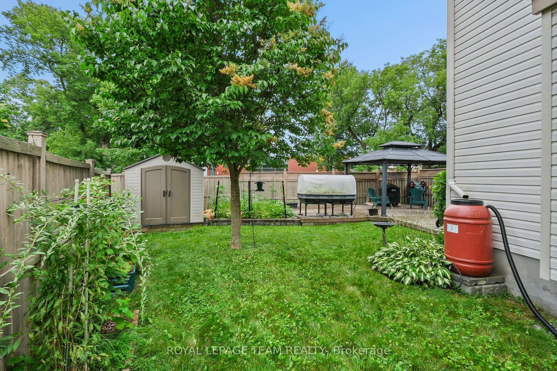 Fenced rear yard with shed.