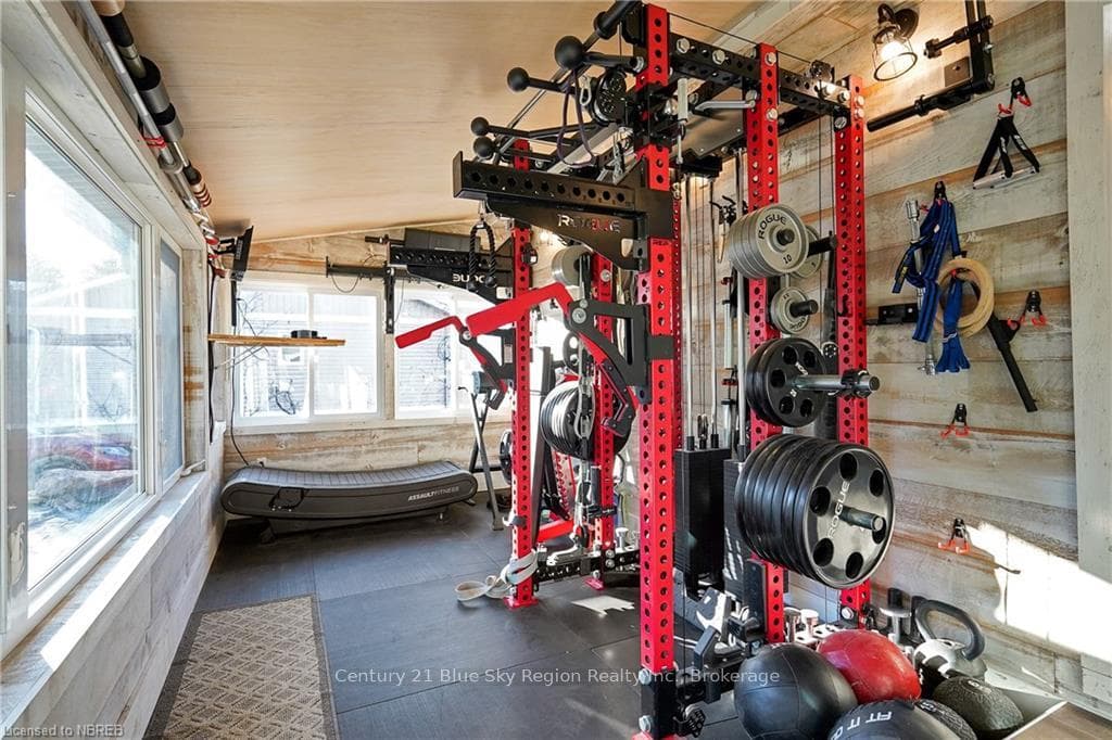 Exercise area featuring lofted ceiling