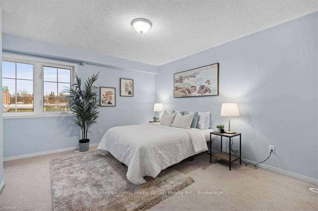 Bedroom with carpet and a textured ceiling