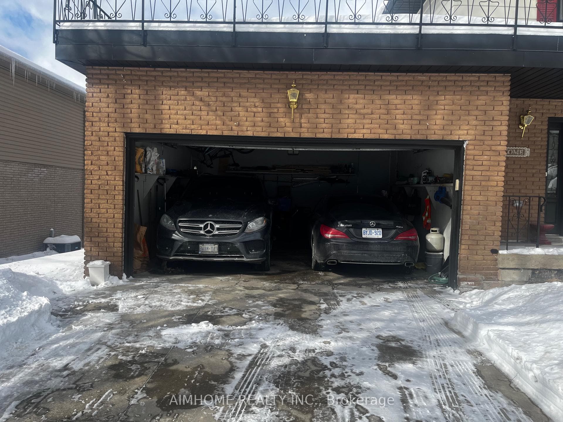 The garage with two cars in.
