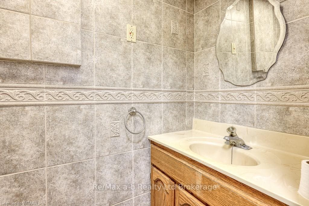 Bathroom featuring vanity and tile walls