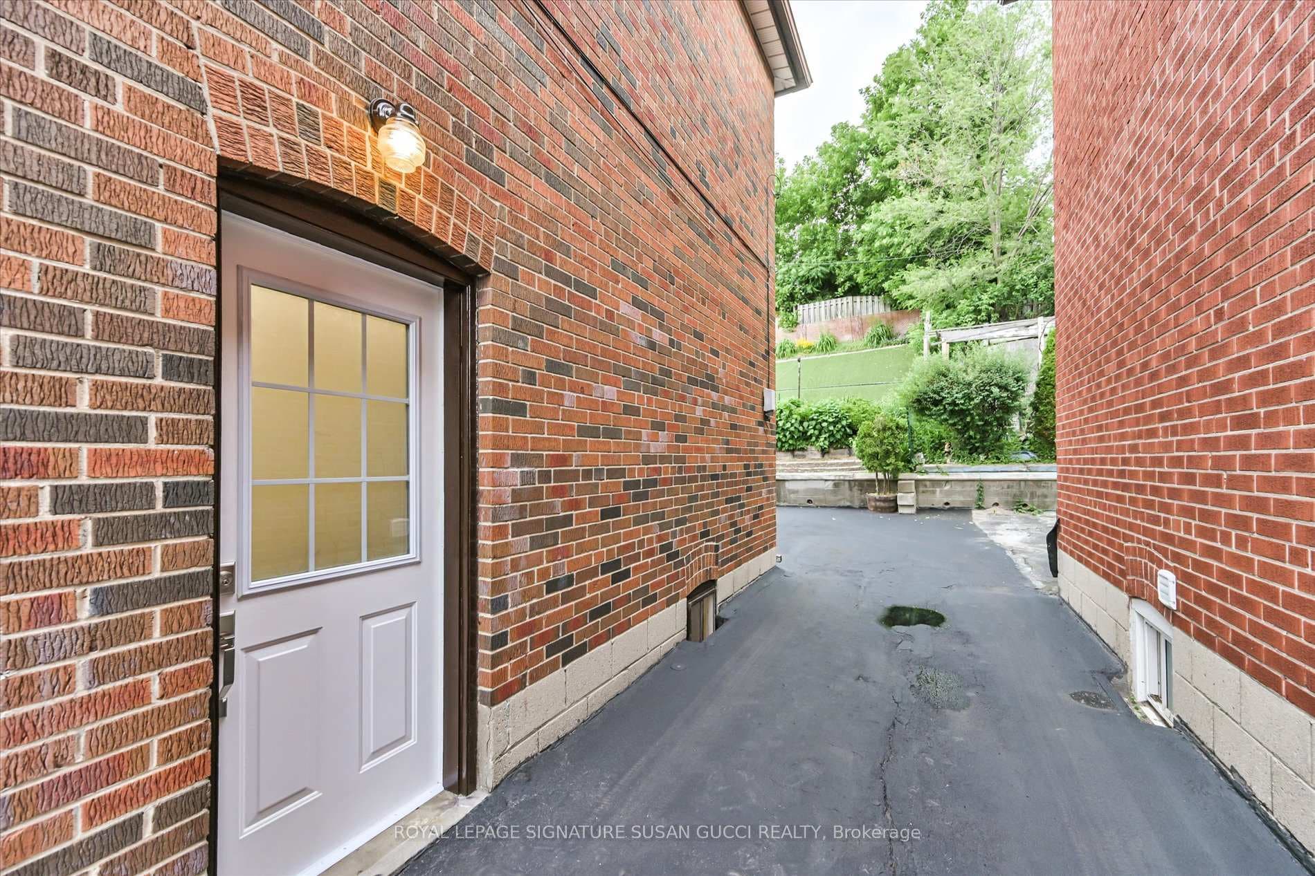 Long driveway for parking at back, side entrance