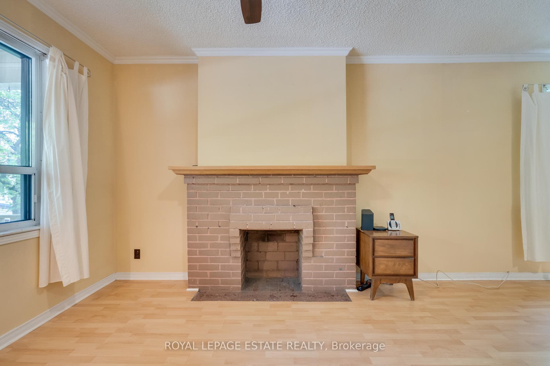sunny main floor living room with fireplace