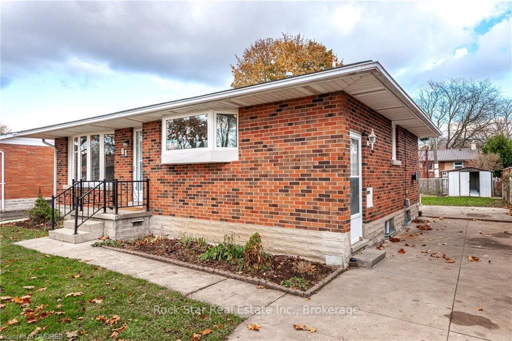 View of front of house with a shed and a patio are