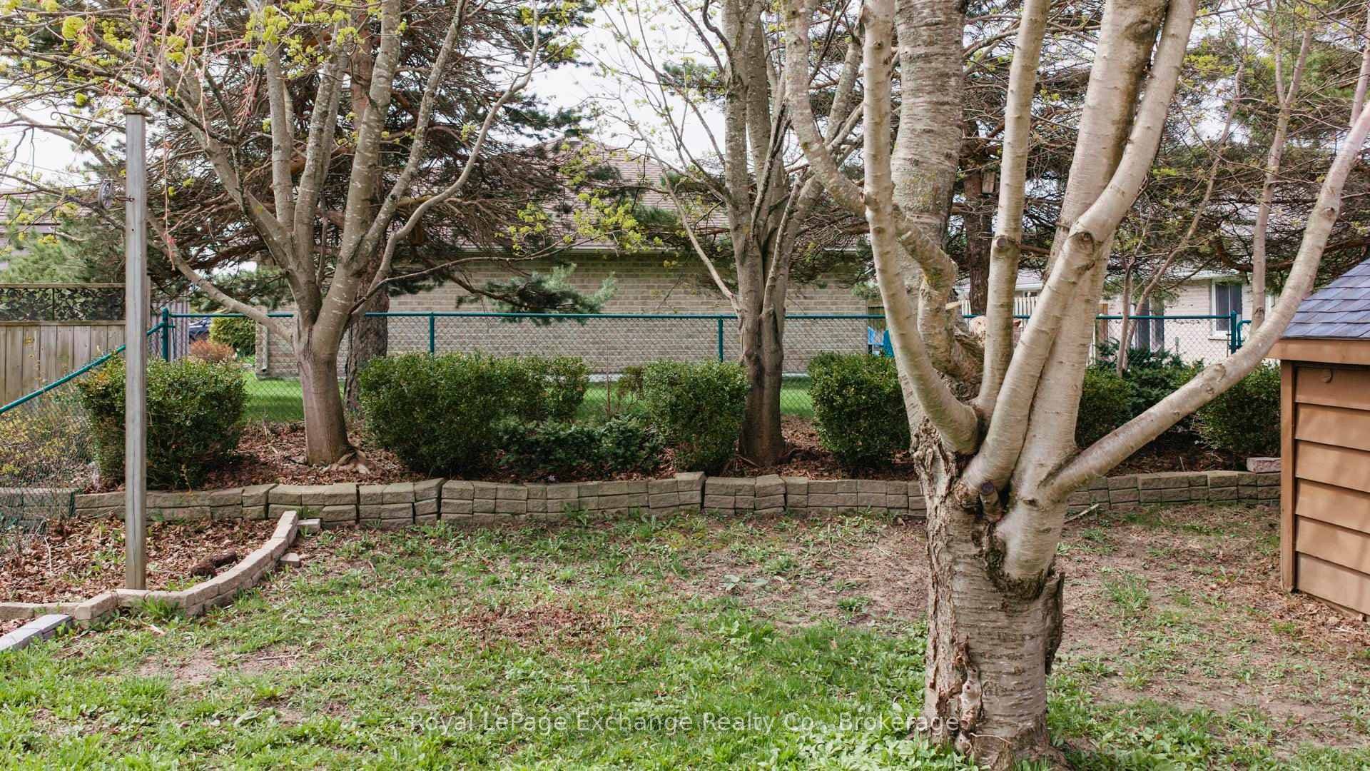 Fully fenced yard with deck and shed
