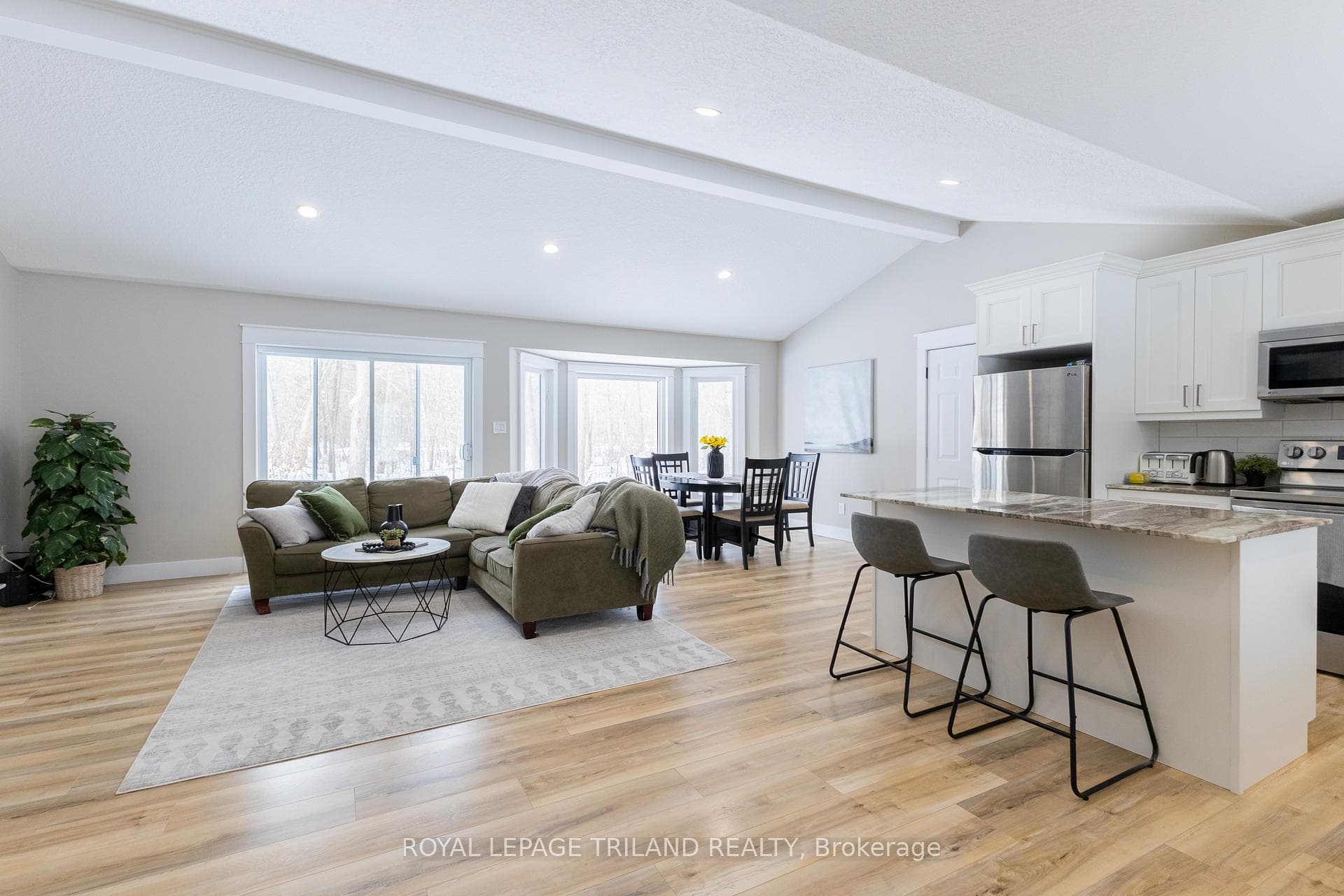 Open concept great room below vaulted ceilings