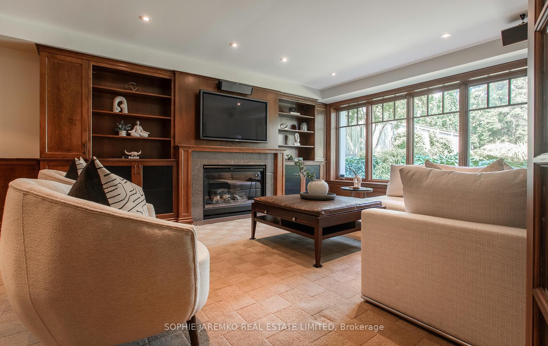 Lower level Fam room w huge windows facing garden.