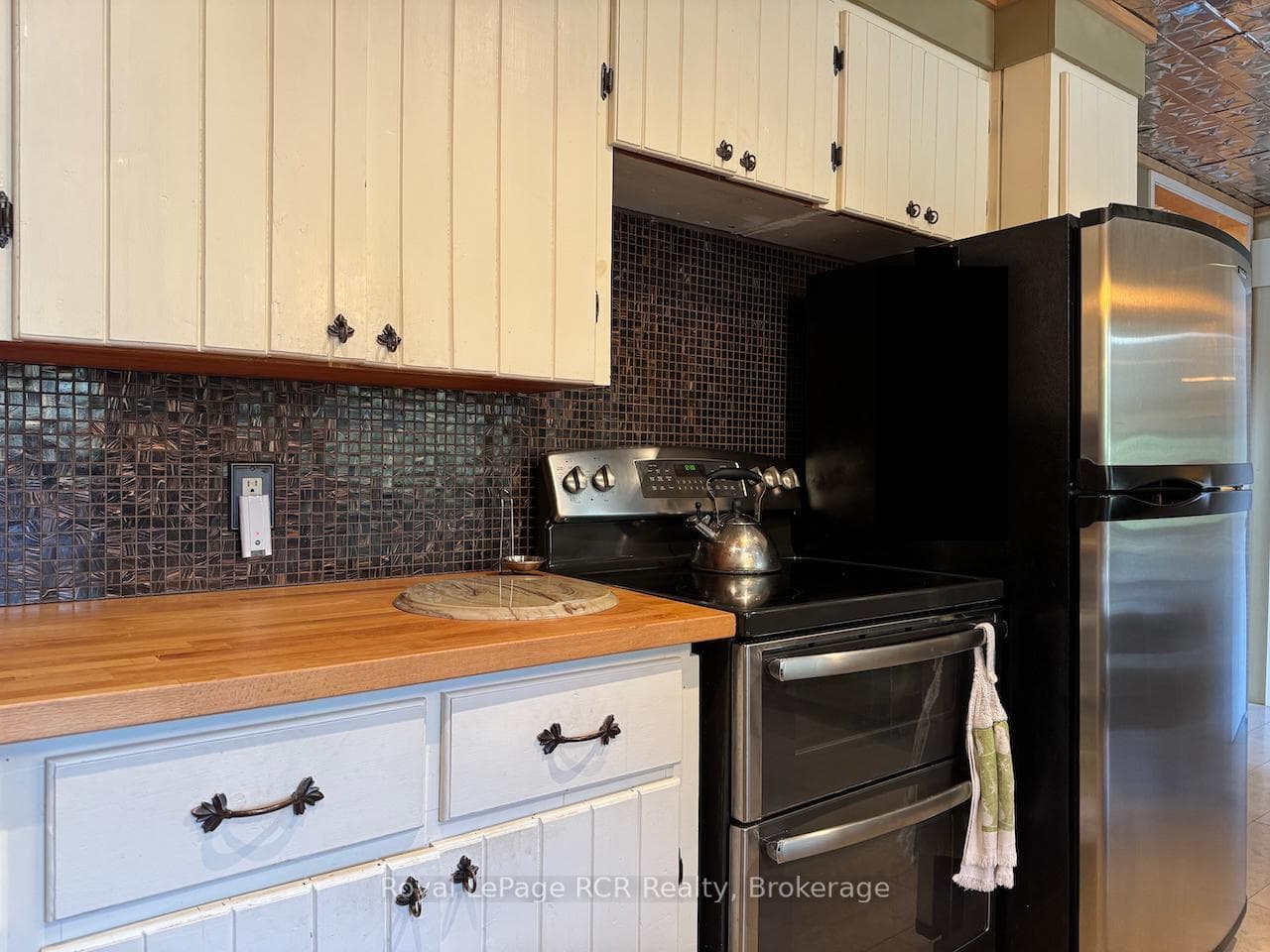 Stainless steel appliances and wood counters.