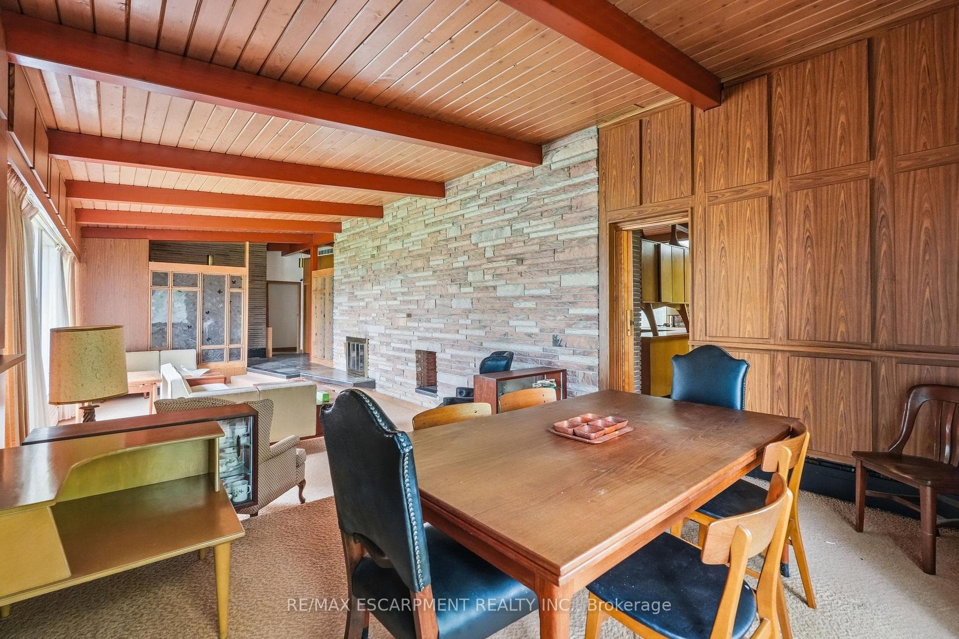 Expansive din area featuring a wood-panel wall