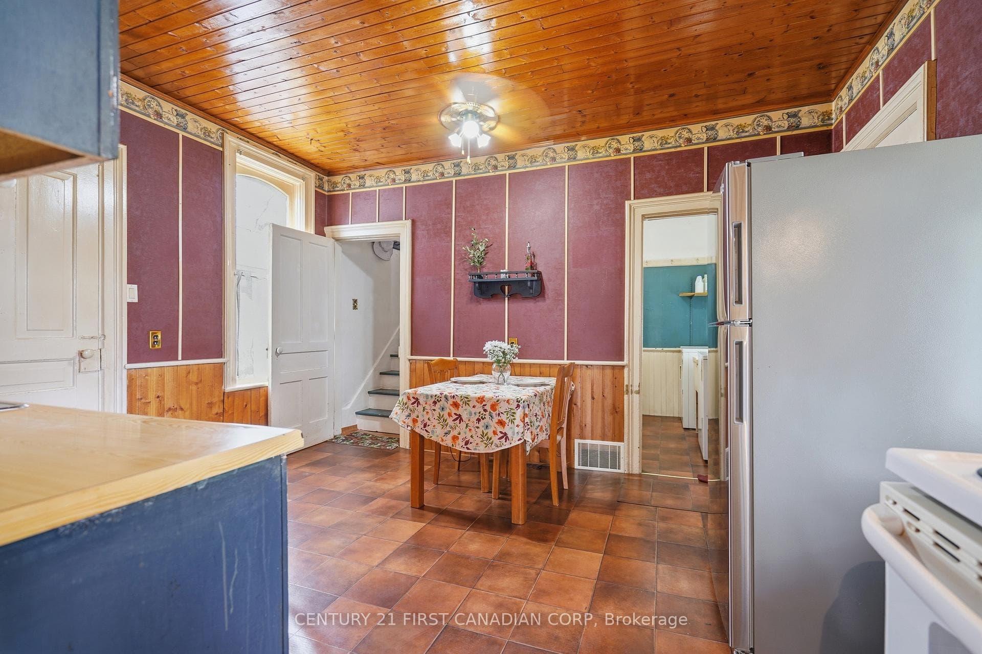 Kitchen w/ staircase to 3rd bedroom