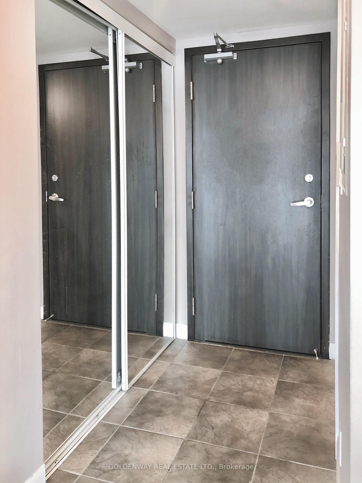 Foyer with mirrored closet