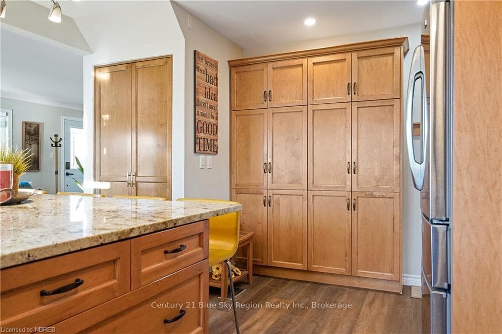 Kitchen featuring stainless steel fridge, dark har