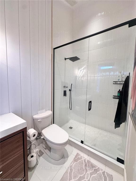 Bathroom with tile patterned floors, vanity, toile