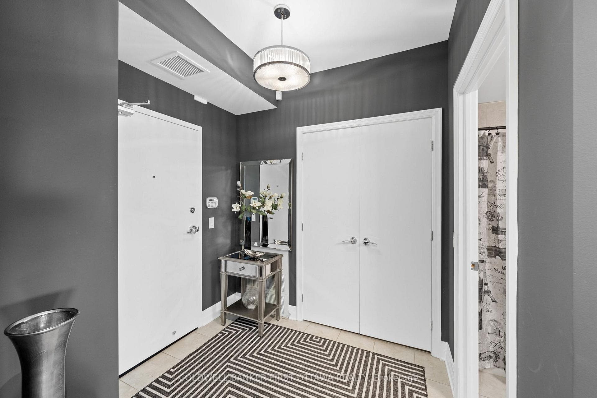 Front foyer w dbl closet & modern fixture above.