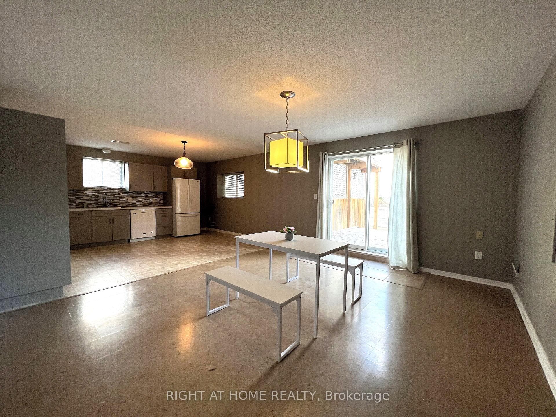 Kitchen and dining area with walk-out to backyard