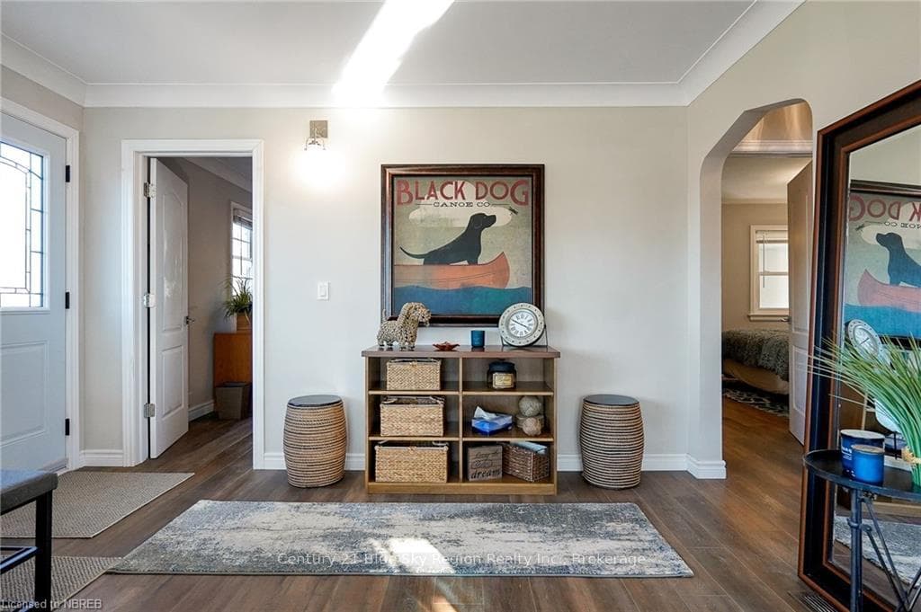 Hall featuring ornamental molding and dark wood-ty