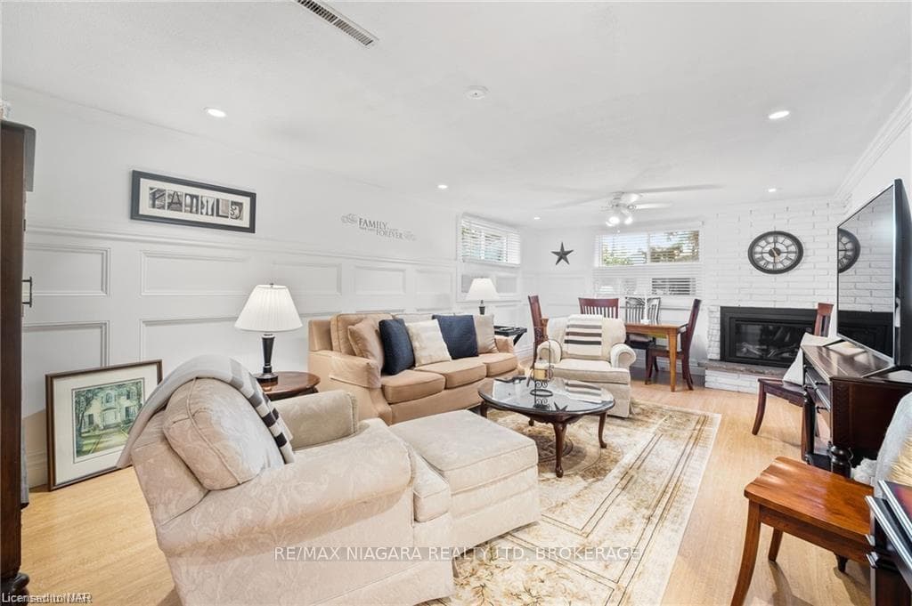 Living room with light hardwood / wood-style floor